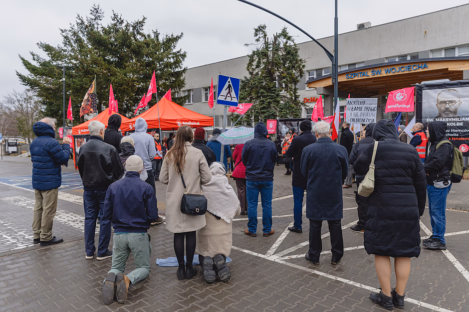 na zdjęciu kilka protestujących osób, w tym kilka osób klęczy